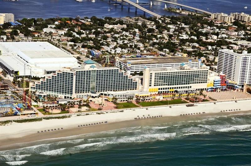 Vibrant beach scene featuring calm waters outside Hilton Daytona Beach Oceanfront Resort.
