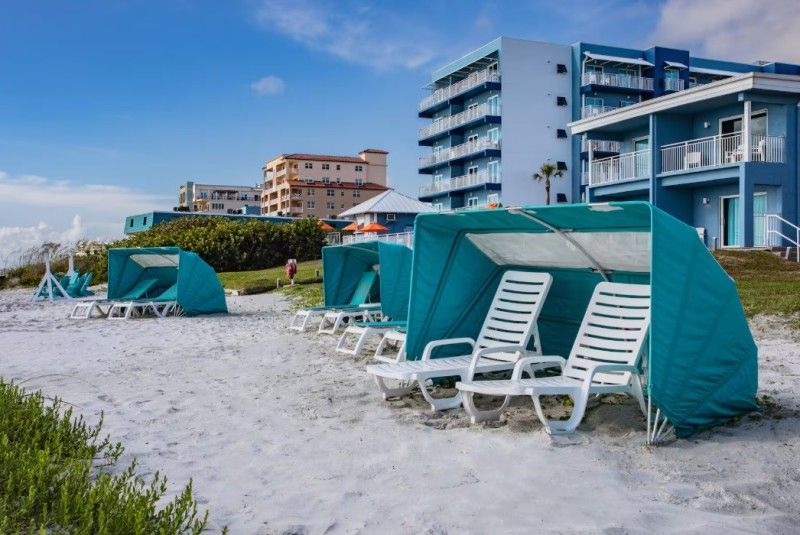 Serene white sandy shoreline steps away from Coconut Palms Beach Resort II in New Smyrna Beach.