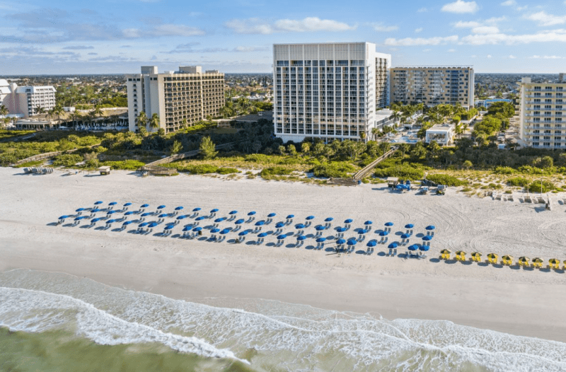 Marriott’s Crystal Shores in Marco Island, Florida with beachfront vistas and swaying palm trees under a clear blue sky