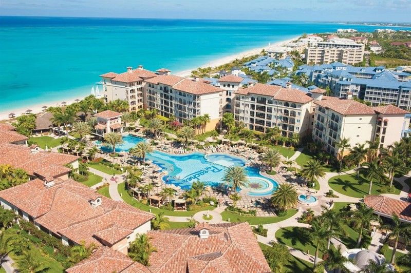 Aerial view of Beaches Turks & Caicos Key West Village with expansive pools, beachfront villas, and lush tropical greenery