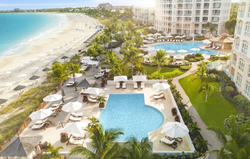 Stunning beachfront view of Seven Stars Resort & Spa on Grace Bay, Turks & Caicos, with pristine white sands and turquoise waters